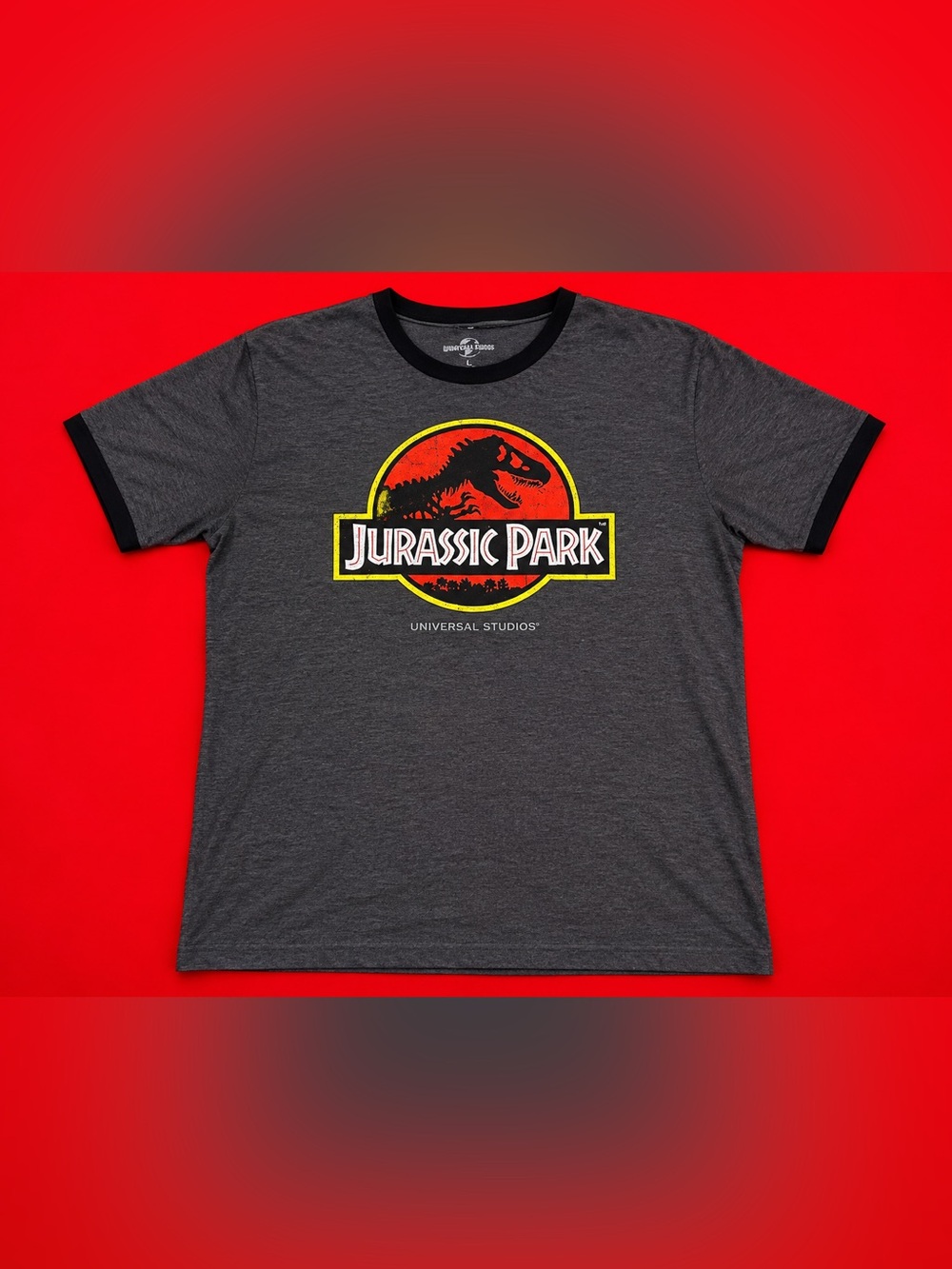 Universal Woman’s Jurassic Park Charcoal Gray Graphic Tee with Red & Yellow Logo